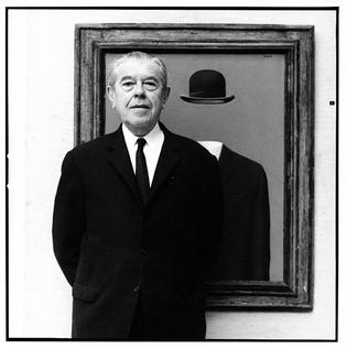 René Magritte in front of his painting, The Pilgrim